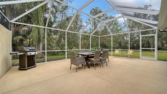 view of patio / terrace with glass enclosure and a grill