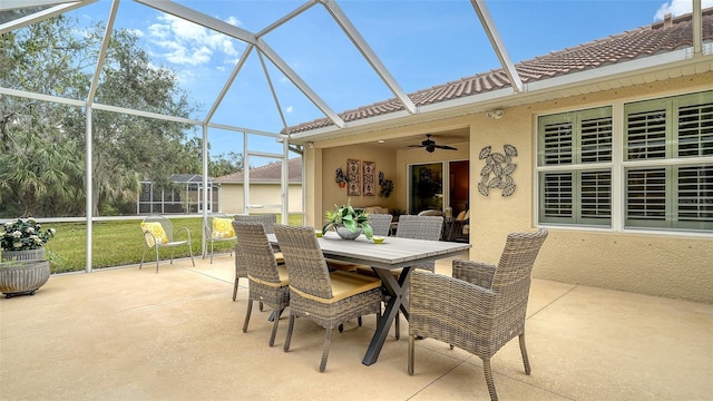 view of patio featuring ceiling fan and a lanai