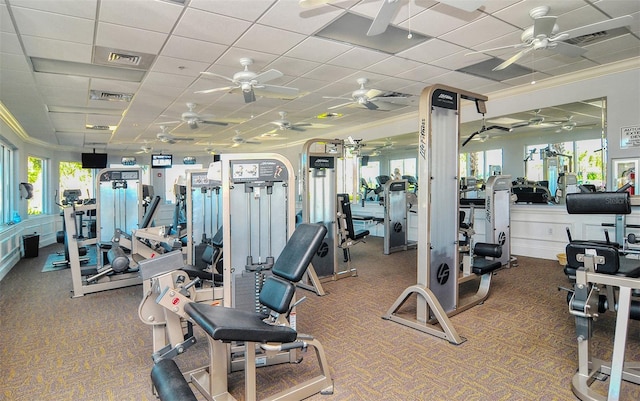 exercise room featuring carpet floors, a paneled ceiling, and crown molding