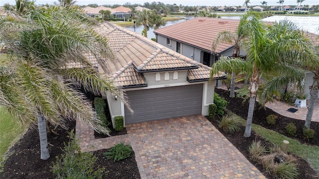 exterior space with a garage and a water view