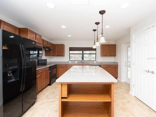 kitchen featuring light stone counters, a center island, hanging light fixtures, light tile patterned floors, and black appliances