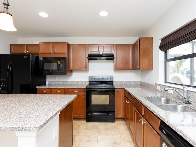 kitchen featuring hanging light fixtures, sink, light tile patterned floors, and black appliances