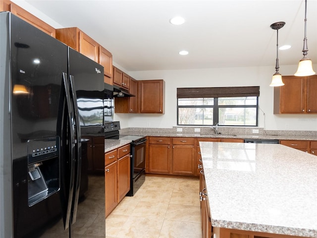 kitchen featuring sink, hanging light fixtures, black appliances, a kitchen island, and light tile patterned flooring