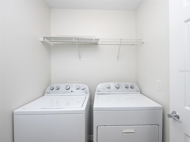 laundry room with washing machine and clothes dryer