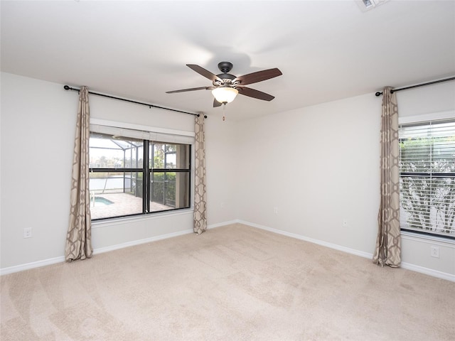 carpeted empty room featuring ceiling fan