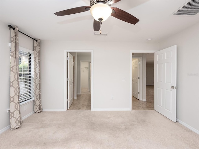 unfurnished bedroom with ceiling fan and light colored carpet