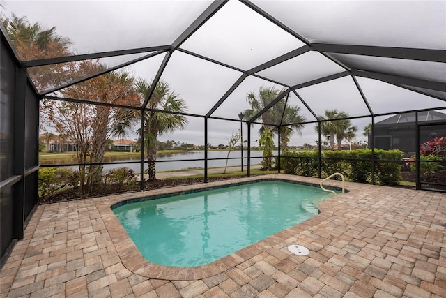 view of pool featuring a patio, a water view, and a lanai