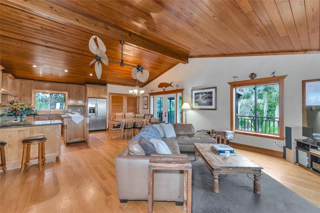 living room featuring ceiling fan with notable chandelier, light wood-type flooring, wood ceiling, and vaulted ceiling with beams