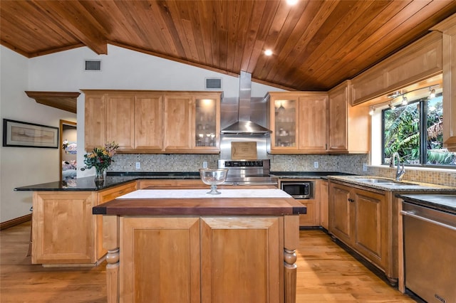 kitchen with wall chimney range hood, a kitchen island, butcher block countertops, light wood-type flooring, and appliances with stainless steel finishes