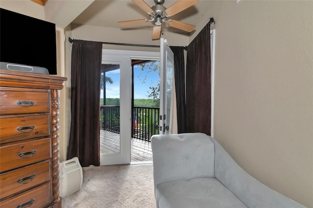 living area featuring ceiling fan and carpet