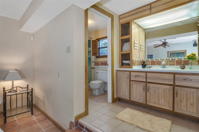 bathroom featuring tile patterned flooring, vanity, decorative backsplash, toilet, and ceiling fan