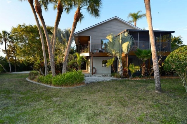 rear view of property featuring a yard