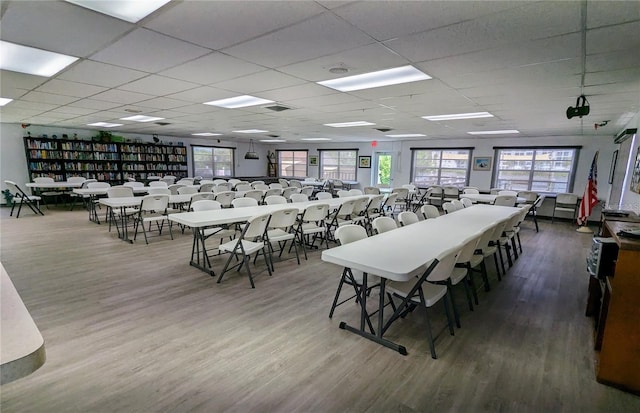 dining room with hardwood / wood-style flooring, plenty of natural light, and a paneled ceiling