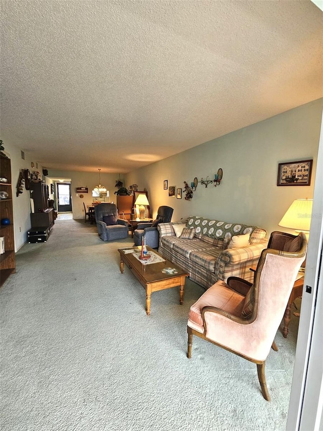 living room featuring carpet and a textured ceiling