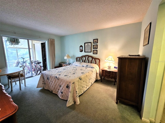 carpeted bedroom with access to exterior and a textured ceiling