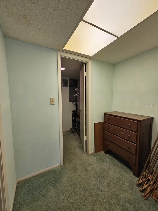 hallway featuring carpet floors and a textured ceiling