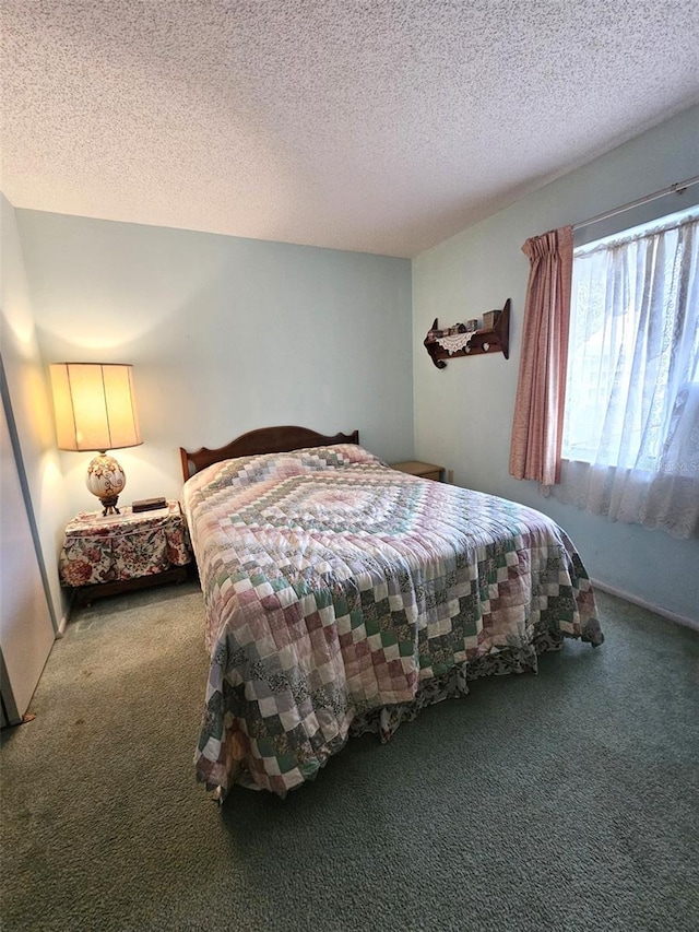 bedroom featuring carpet and a textured ceiling