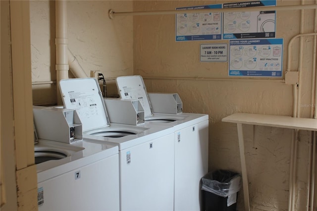 clothes washing area featuring washer and clothes dryer