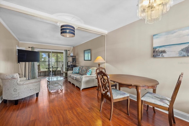 dining space featuring ornamental molding, a chandelier, and wood-type flooring