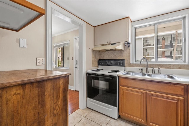 kitchen with sink, light tile patterned flooring, ornamental molding, tasteful backsplash, and range with electric stovetop