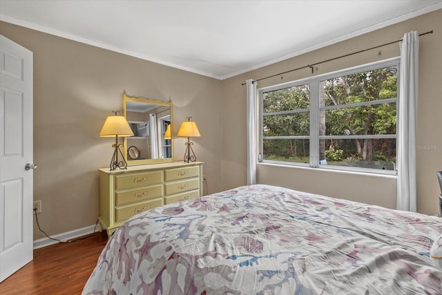 bedroom with ornamental molding and dark wood-type flooring