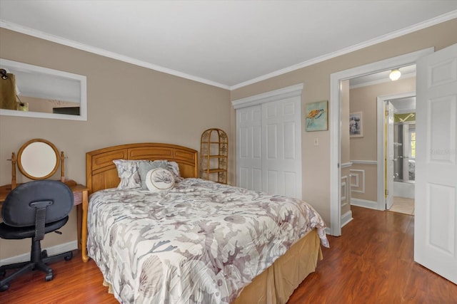 bedroom with ornamental molding, a closet, and dark hardwood / wood-style floors