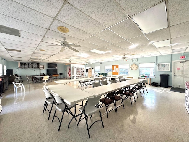 dining area with a drop ceiling and a healthy amount of sunlight