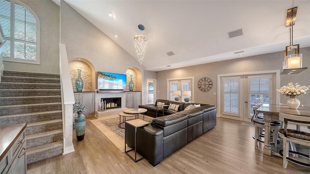 living room featuring light hardwood / wood-style floors and high vaulted ceiling