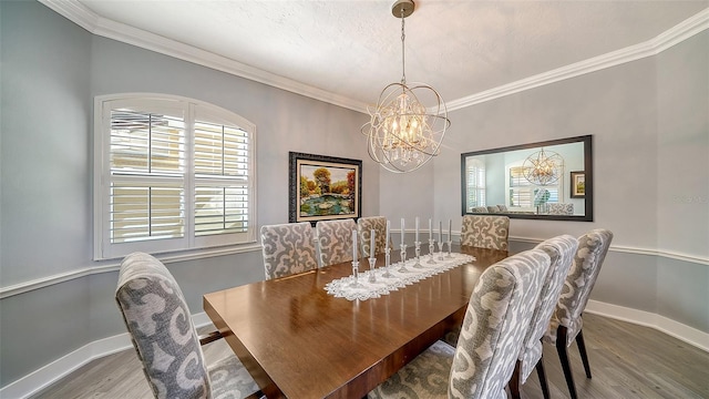 dining room featuring crown molding, a chandelier, and hardwood / wood-style flooring