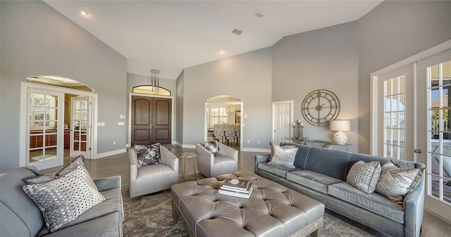 living room with french doors, a healthy amount of sunlight, and high vaulted ceiling