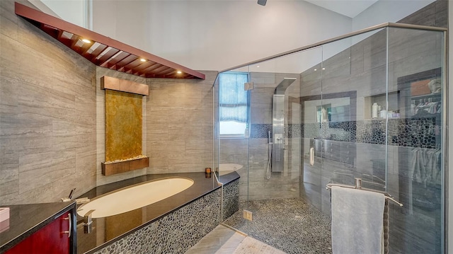 bathroom with vanity and separate shower and tub