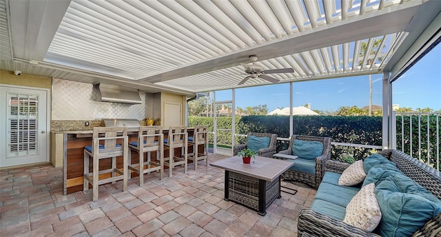 view of patio with a bar, ceiling fan, an outdoor hangout area, and a pergola