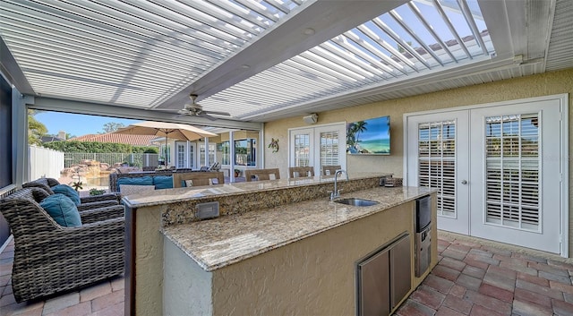 view of patio / terrace with french doors, ceiling fan, a pergola, and sink