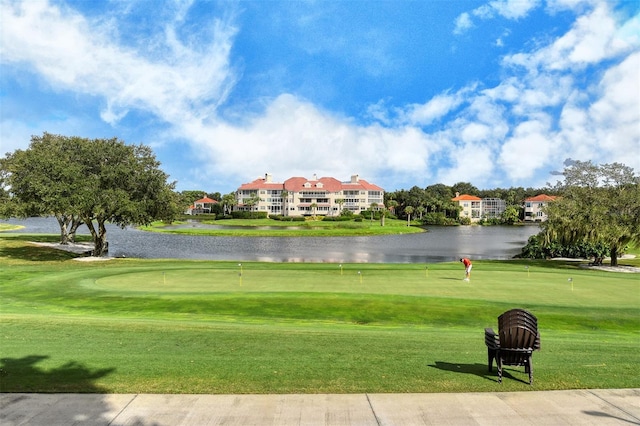 view of home's community featuring a water view and a lawn