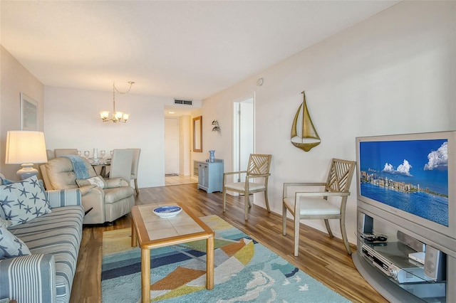 living room featuring a chandelier and hardwood / wood-style flooring