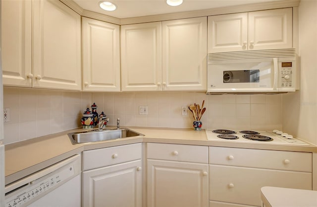 kitchen with decorative backsplash, white cabinetry, white appliances, and sink