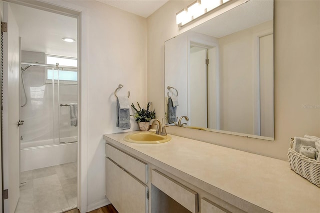 bathroom featuring shower / bath combination with glass door and vanity