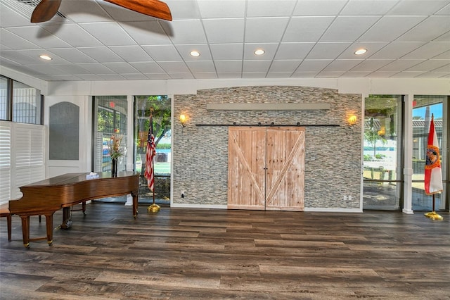 miscellaneous room featuring a barn door and ceiling fan