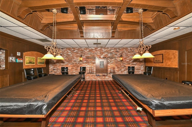 recreation room with wood walls, carpet floors, brick wall, and pool table