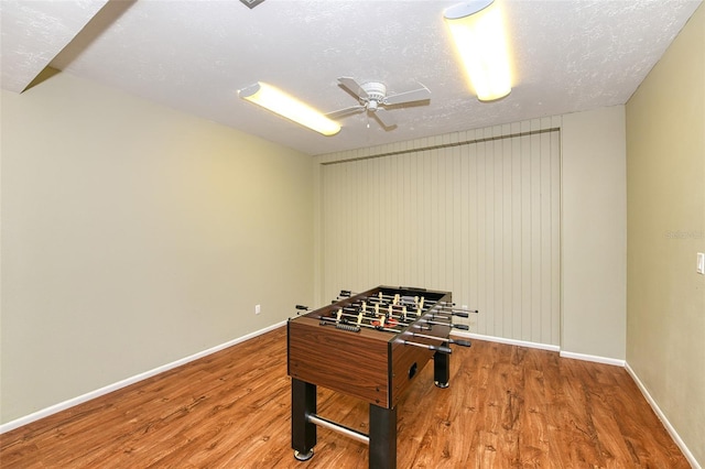 playroom featuring a textured ceiling, hardwood / wood-style flooring, and ceiling fan