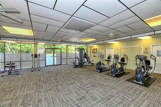 workout area with ceiling fan and carpet