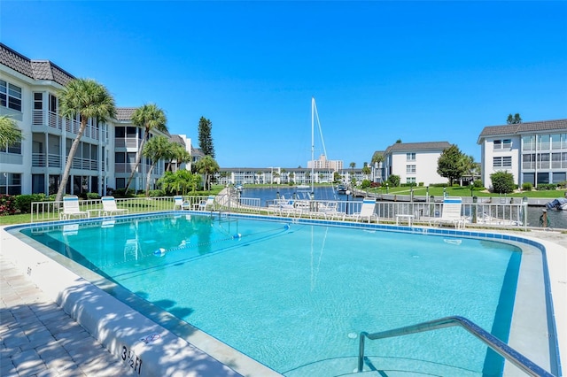 view of swimming pool featuring a water view