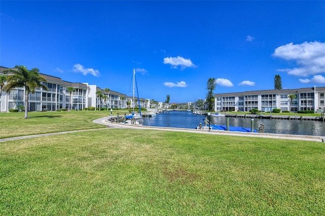 view of pool featuring a water view and a lawn