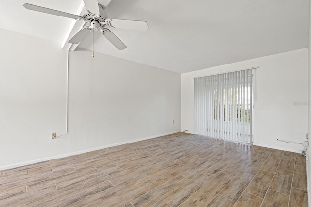 empty room with ceiling fan and light hardwood / wood-style flooring