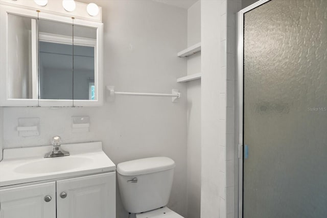 bathroom featuring walk in shower, vanity, and toilet