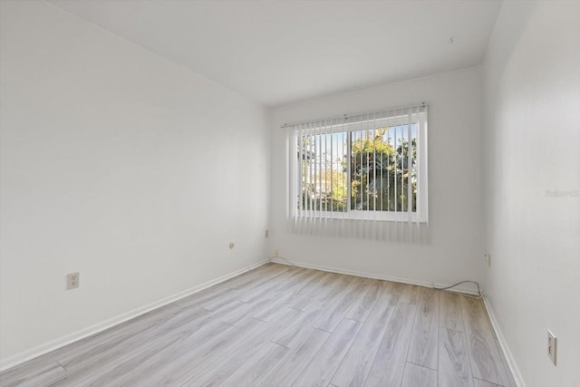 unfurnished room with light wood-type flooring