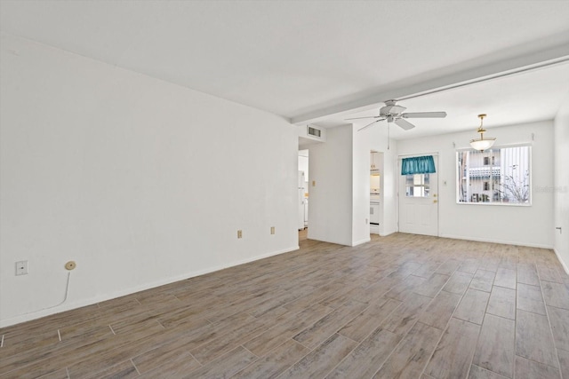 unfurnished living room featuring ceiling fan and wood-type flooring