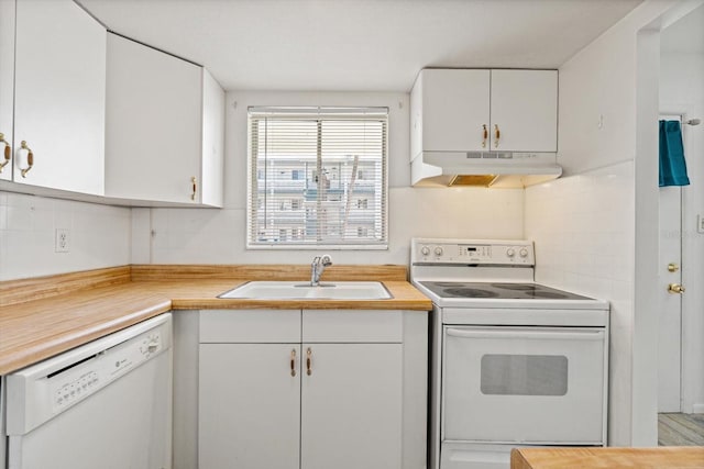 kitchen featuring tasteful backsplash, sink, white cabinets, and white appliances