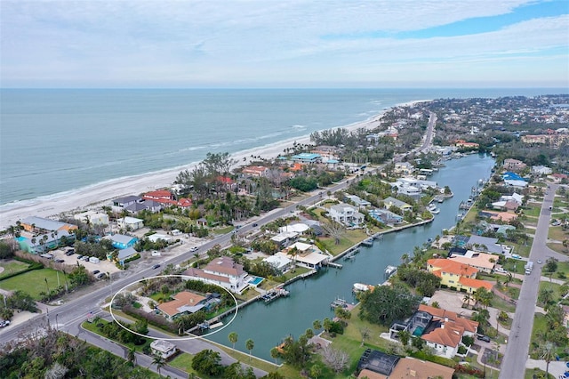 birds eye view of property featuring a water view and a beach view