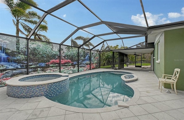 view of pool with glass enclosure, a patio area, and an in ground hot tub